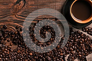 Coffee cup and beans frame on wooden table