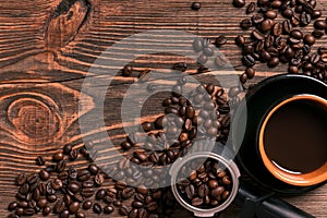 Coffee cup and beans frame on wooden table