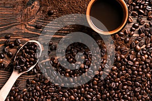 Coffee cup and beans frame on wooden table