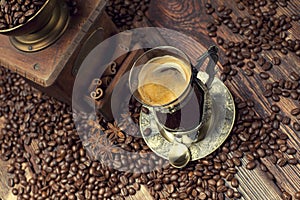 Coffee cup and beans, old coffee grinder