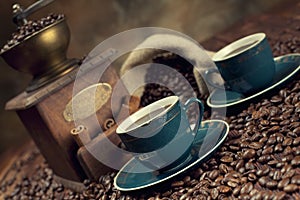 Coffee cup, beans and old grinder