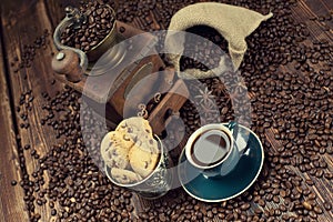 Coffee cup and beans, old grinder and sack