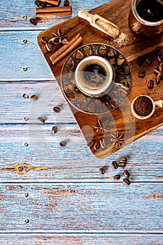 Coffee cup, beans and spices on old kitchen table. Top view with copyspace for your text