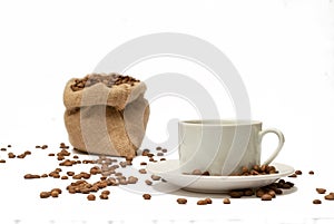 Coffee cup with beans spilled on the table