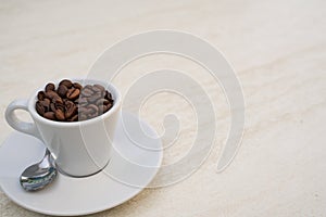 Coffee cup and beans on a white background. Top view with copy space for your text