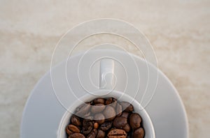 Coffee cup and beans on a white background. Top view with copy space for your text