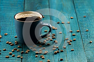 Coffee Cup and beans on wooden background