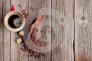 Coffee cup and beans on wooden table