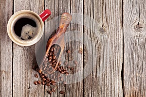 Coffee cup and beans on wooden table
