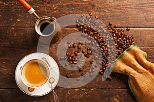 Coffee cup and beans on wooden table