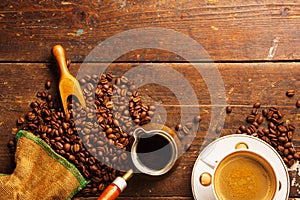 Coffee cup and beans on wooden table