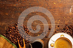 Coffee cup and beans on wooden table