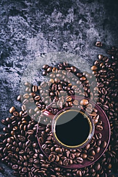 Coffee. Cup of black coffee and spilled coffee beans. Coffee break