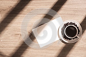 Coffee cup and blank paper top view on wooden table background w