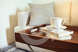 Coffee cup Books on table wooden tray Pillow on sofa Home Interior