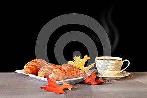 Coffee cup and breakfast  and autumn maple leaves are on a wooden table