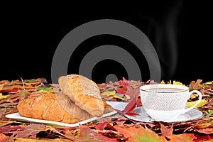 Coffee cup and breakfast  and autumn maple leaves are on a wooden table