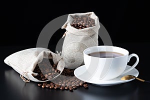 Coffee cup with burlap sack of roasted beans