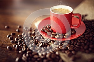 Coffee cup on burlap sack with roasted beans