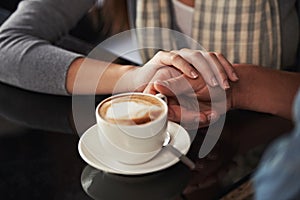 Coffee cup, cafe and relax couple holding hands for support, comfort or love on morning date with caffeine beverage