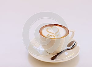 Coffee cup, cappuccino and heart in foam in studio isolated with white background. Cafe drink, love writing and foamy