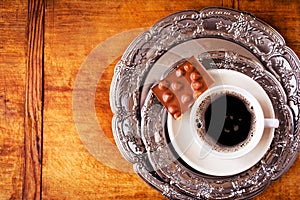 Coffee cup and chocolate on vintage plate