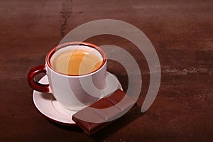 Coffee cup and chocolate on wooden table texture. Coffeebreak