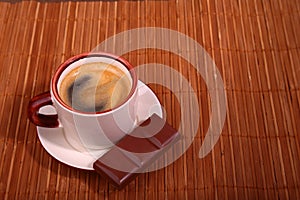 Coffee cup and chocolate on wooden table texture. Coffeebreak