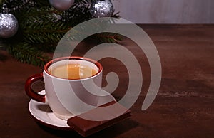 Coffee cup and chocolate on wooden table texture. Coffeebreak. Christmas time