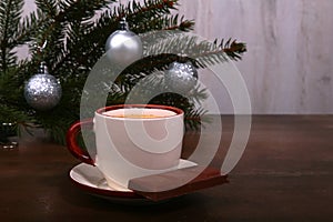 Coffee cup and chocolate on wooden table texture. Coffeebreak. Christmas time