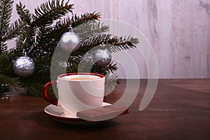 Coffee cup and chocolate on wooden table texture. Coffeebreak. Christmas time