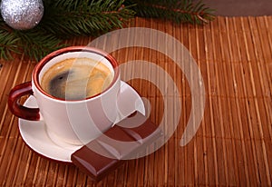 Coffee cup and chocolate on wooden table texture. Coffeebreak. Christmas time