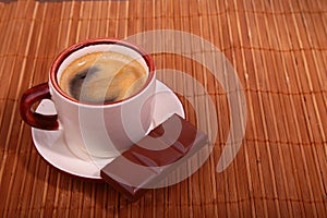 Coffee cup and chocolate on wooden table texture. Coffeebreak