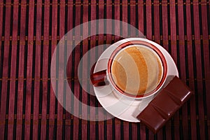 Coffee cup and chocolate on wooden table texture. Coffeebreak