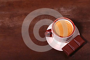 Coffee cup and chocolate on wooden table texture. Coffeebreak