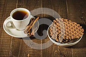 coffee cup with cinnamon and chocolate cookies/coffee cup with cinnamon and chocolate cookies on a wooden background. Top view