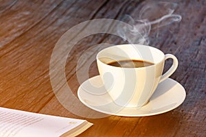 coffee cup clock and news paper on old wooden table