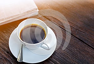 coffee cup clock and news paper on old wooden table nature background