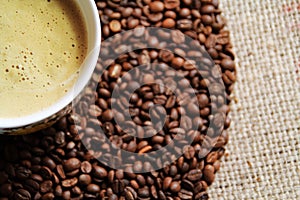 Coffee cup on coffee bean background