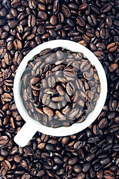 Coffee cup on coffee beans