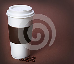 Coffee cup with Coffee Beans on brown background. Takeaway