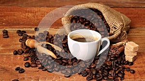 Coffee cup with Coffee beans, burlap sack and with cinnamon sticks