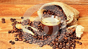 Coffee cup with Coffee beans, burlap sack and with cinnamon sticks