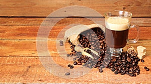 Coffee cup with Coffee beans, burlap sack and with cinnamon sticks