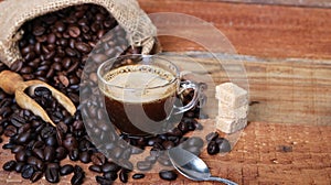 Coffee cup with Coffee beans, burlap sack and with cinnamon sticks