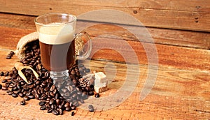 Coffee cup with Coffee beans, burlap sack and with cinnamon sticks