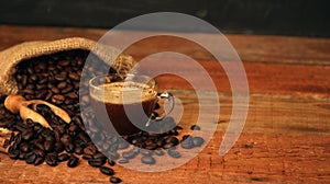 Coffee cup with Coffee beans, burlap sack and with cinnamon sticks