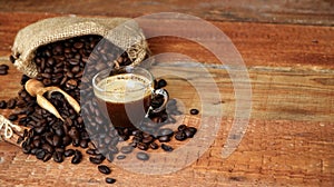 Coffee cup with Coffee beans, burlap sack and with cinnamon sticks