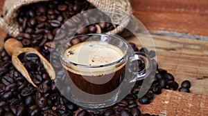 Coffee cup with Coffee beans, burlap sack and with cinnamon sticks