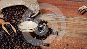 Coffee cup with Coffee beans, burlap sack and with cinnamon sticks